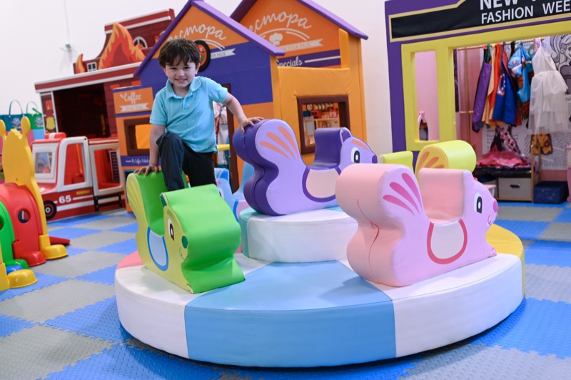 A child riding the carousel