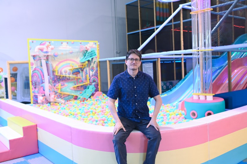 Co-founder beside the ball pit