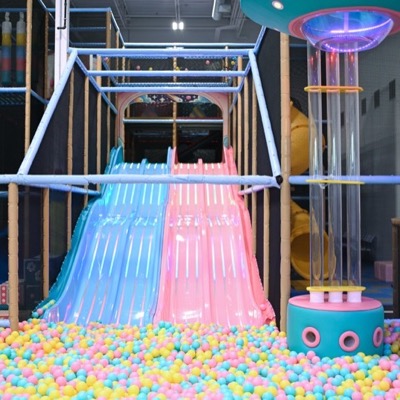 The twin LED racing slides at Space Play Academy, running down into the ball pit